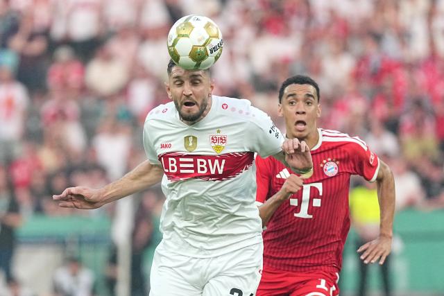23 May 2026, Berlin: Stuttgart's Jeff Chabot (L) and Bayern Munich's Jamal Musiala battle for the ball during the German DFB Cup Final between Bayern Munich and VfB Stuttgart at the Olympic Stadium in Berlin. Photo: Michael Kappeler/dpa
