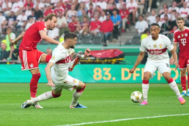 23 May 2026, Berlin: Bayern Munich's Harry Kane (L) takes a shot against Stuttgart's Jeff Chabot during the German DFB Cup Final between Bayern Munich and VfB Stuttgart at the Olympic Stadium in Berlin. Photo: Michael Kappeler/dpa