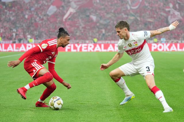 23 May 2026, Berlin: Bayern Munich's Michael Olise (L) and Stuttgart's Ramon Hendriks battle for the ball during the German DFB Cup Final between Bayern Munich and VfB Stuttgart at the Olympic Stadium in Berlin. Photo: Michael Kappeler/dpa