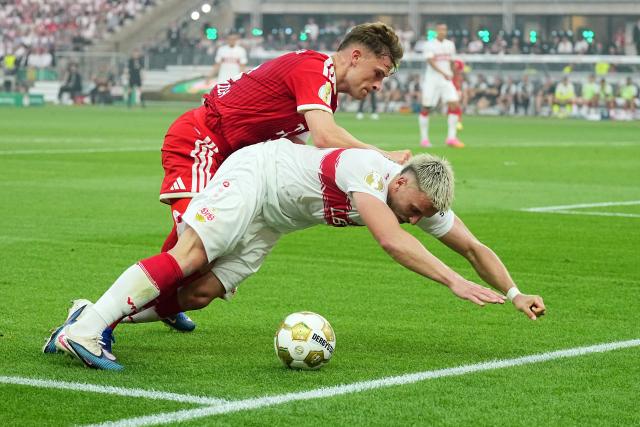 23 May 2026, Berlin: Bayern Munich's Joshua Kimmich (L) and Stuttgart's Ermedin Demirovic battle for the ball during the German DFB Cup Final between Bayern Munich and VfB Stuttgart at the Olympic Stadium in Berlin. Photo: Michael Kappeler/dpa