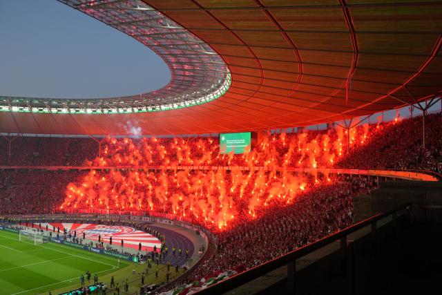 23 May 2026, Berlin: Bayern Munich fans celebrate with fireworks during the German DFB Cup Final between Bayern Munich and VfB Stuttgart at the Olympic Stadium in Berlin. Photo: Soeren Stache/dpa