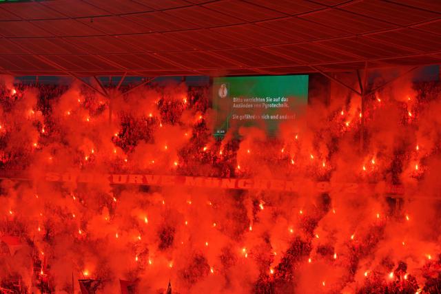 23 May 2026, Berlin: Bayern Munich fans celebrate with fireworks during the German DFB Cup Final between Bayern Munich and VfB Stuttgart at the Olympic Stadium in Berlin. Photo: Soeren Stache/dpa