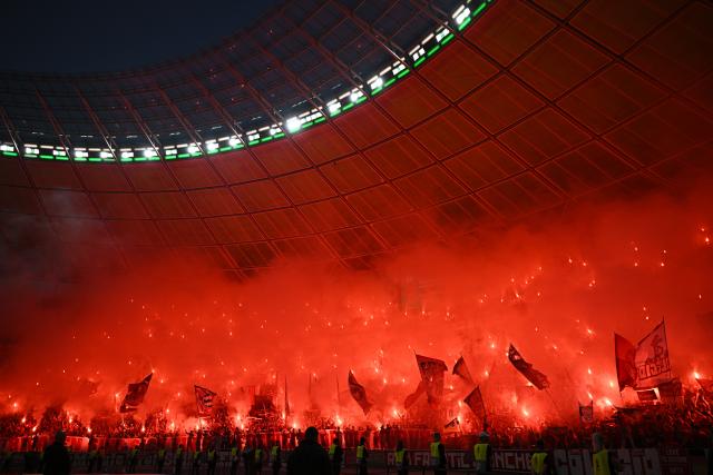 23 May 2026, Berlin: Bayern Munich fans celebrate with fireworks during the German DFB Cup Final between Bayern Munich and VfB Stuttgart at the Olympic Stadium in Berlin. Photo: Tom Weller/dpa