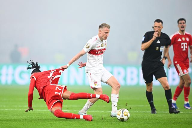 23 May 2026, Berlin: Stuttgart's Chris Fuehrich fouls Bayern Munich's Michael Olise (L) during the German DFB Cup Final between Bayern Munich and VfB Stuttgart at the Olympic Stadium in Berlin. Photo: Tom Weller/dpa