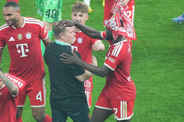 23 May 2026, Berlin: Bayern Munich's Dayot Upamecano (R) celebrates with Max Eberl, Bayern Munich's sporting director, afte winning the German DFB Cup Final against VfB Stuttgart at the Olympic Stadium in Berlin. Photo: Soeren Stache/dpa