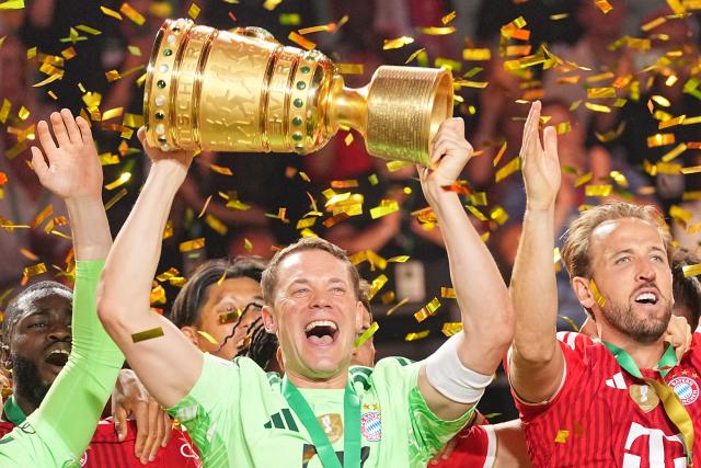 23 May 2026, Berlin: Bayern Munich players celebrate with the trophy after winning the German DFB Cup Final against VfB Stuttgart at the Olympic Stadium in Berlin. Photo: Michael Kappeler/dpa