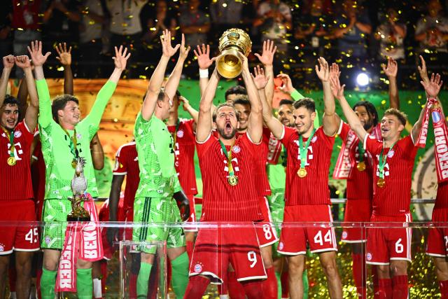 23 May 2026, Berlin: Bayern Munich players celebrate with the trophy after winning the German DFB Cup Final against VfB Stuttgart at the Olympic Stadium in Berlin. Photo: Tom Weller/dpa