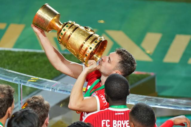 23 May 2026, Berlin: Bayern Munich players celebrate with the trophy after winning the German DFB Cup Final against VfB Stuttgart at the Olympic Stadium in Berlin. Photo: Soeren Stache/dpa