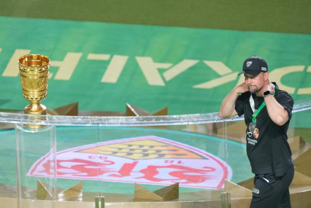 23 May 2026, Berlin: Stuttgart coach Sebastian Hoeness walks past the trophy after lossing the German DFB Cup Final to Bayern Munich at the Olympic Stadium in Berlin. Photo: Soeren Stache/dpa