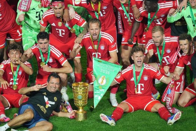 23 May 2026, Berlin: Bayern Munich players celebrate with the trophy after winning the German DFB Cup Final against VfB Stuttgart at the Olympic Stadium in Berlin. Photo: Soeren Stache/dpa