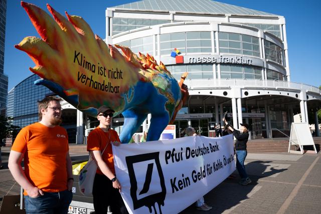 28 May 2026, Hesse, Frankfurt_Main: Members of the Attac movement protest in front of the Frankfurt Exhibition Center, where Deutsche Bank is holding its annual shareholders' meeting. Photo: Florian Wiegand/dpa