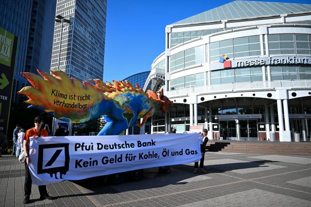 28 May 2026, Hesse, Frankfurt_Main: Members of the Attac movement protest in front of the Frankfurt Exhibition Center, where Deutsche Bank is holding its annual shareholders' meeting. Photo: Florian Wiegand/dpa