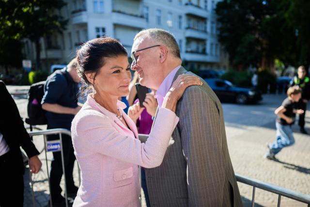 28 May 2026, Berlin: Sahra Wagenknecht (L), founder of the Sahra Wagenknecht Alliance (BSW) and chair of the party's Core Values Commission, and Michael Lueders, the BSW's top candidate for the Berlin House of Representatives election, greet each other at a BSW rally at Lucie-Leydicke-Platz in Berlin-Schoeneberg. Ahead of the Berlin House of Representatives election on September 20, 2026, the BSW is hosting a rally and inviting attendees to join party founder Wagenknecht for a visit to a local pub. Photo: Christoph Soeder/dpa