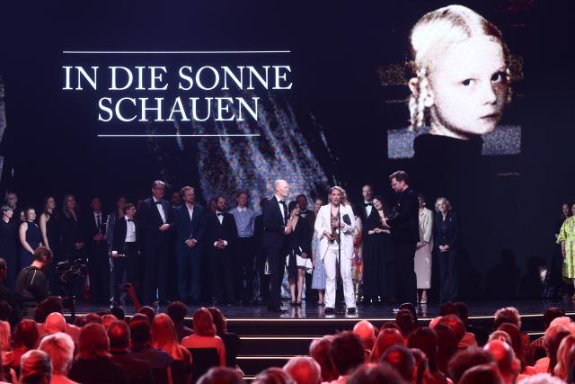29 May 2026, Berlin: Producers Lucas Schmidt, Maren Schmitt, and Lasse Scharpen pose on stage after winning the Golden Lola for Best Feature Film for "Sound of Falling" during the German Film Awards in Berlin. Photo: Christoph Soeder/dpa