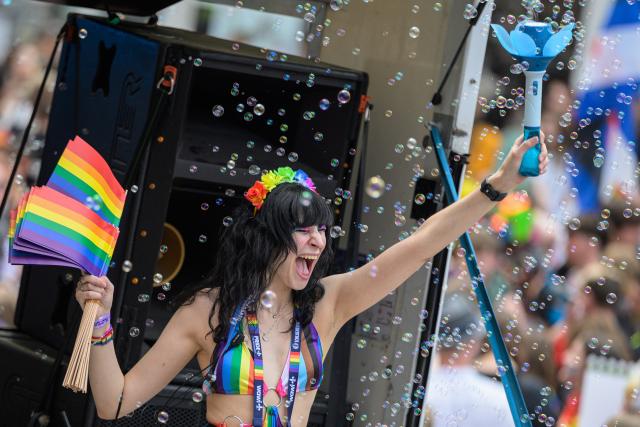 30 May 2026, Hesse, Wiesbaden: A demonstrator wearing colorful face paint is surrounded by soap bubbles during the Christopher Street Day event in Wiesbaden. According to the organizers, the group "Warmes Wiesbaden" plans to use Saturday's Pride event to stand up for an open society and against discrimination and anti-queer sentiment. Photo: Hannes P. Albert/dpa