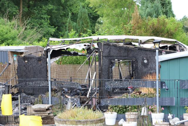 03 June 2026, North Rhine-Westphalia, Niederkrüchten: A view shows the charred and burnt-out remains of a holiday plot at a campsite near Oberhof, following a massive overnight fire. The late-evening blaze destroyed multiple caravans and wooden cabins before more than 100 firefighters brought it under control. Photo: --/dpa