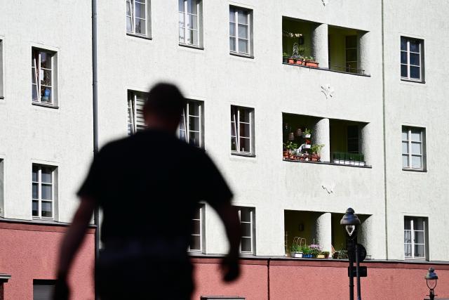FILED - 28 May 2026, Berlin: FILE PHOTO - A man walks in front of apartment buildings. Photo: Sebastian Gollnow/dpa