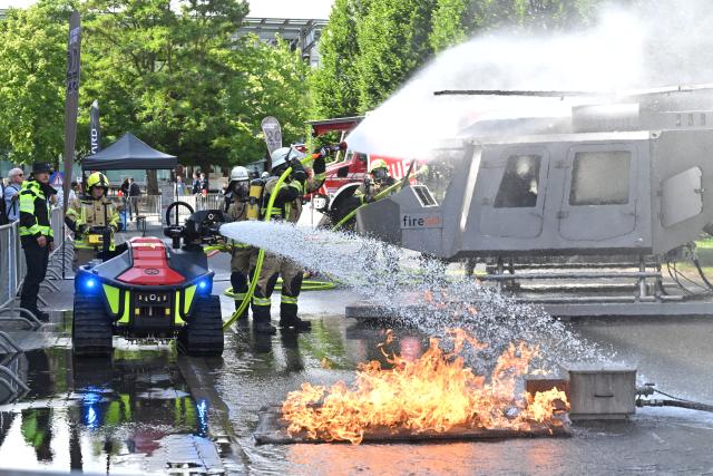 03 June 2026, Lower Saxony, Hannover: Firefighters extinguish a replica helicopter inside a fire simulation system during the S-Gard Safety Tour at the Interschutz trade fair in Hannover. Photo: Julian Stratenschulte/dpa