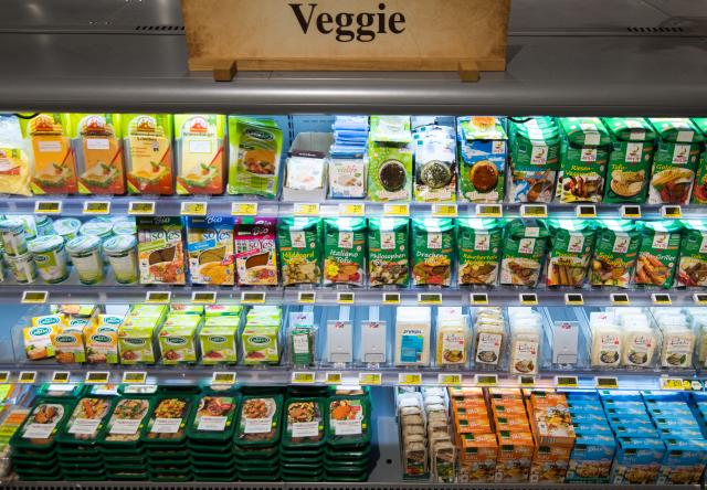 FILED - 11 May 2015, Hamburg: FILE PHOTO - A sign reading "Veggie" stands on a refrigerated shelf stocked with vegetarian products in a supermarket in Hamburg. Photo: picture alliance / dpa