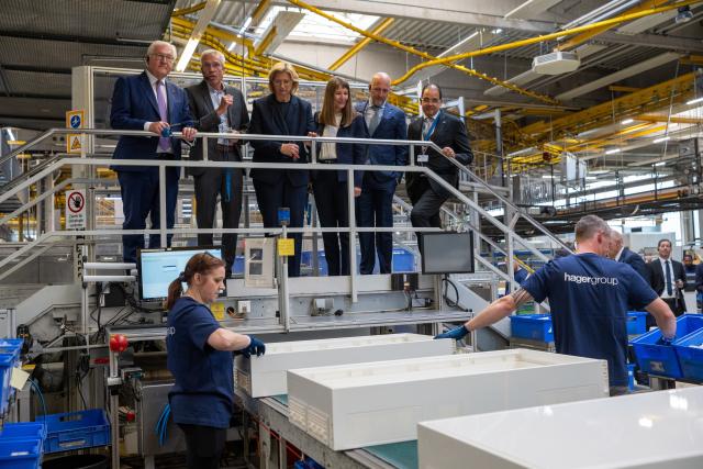 03 June 2026, Saarland, ---: German President Frank-Walter Steinmeier (Top-L) observes a turnkey installation team during a visit to the Hager Group facility in Blieskastel. Photo: Harald Tittel/dpa