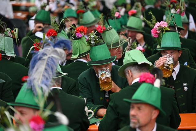 04 June 2026, Bavaria, Wackersberg: The mountain marksmen sit in the beer garden after the Corpus Christi procession. Photo: Sven Hoppe/dpa