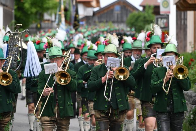 04 June 2026, Bavaria, Wackersberg: Believers in traditional costumes parade through the town during a Corpus Christi procession. Photo: Sven Hoppe/dpa