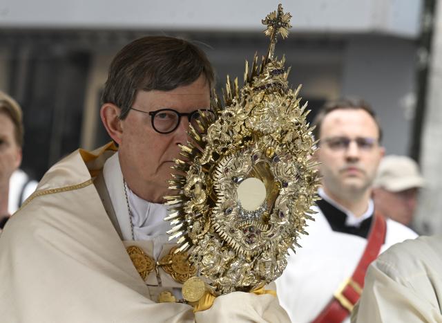 04 June 2026, Bavaria, Wackersberg: Cardinal Rainer Maria Woelki carries a monstrance on Roncalli Square in front of the cathedral during the Corpus Christi procession. Photo: Roberto Pfeil/dpa
