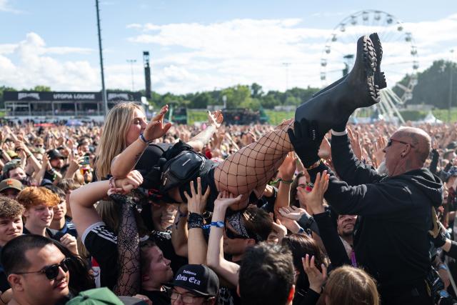 05 June 2026, Bavaria, Nuremberg: A female audience member is carried by the crowd while crowd-surfing during a concert at the Rock im Park open-air festival. Photo: Daniel Karmann/dpa