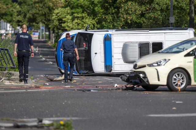 06 June 2026, Berlin: An overturned police car is lying on the road. Eight people were injured in a collision between a taxi and a police car, two of them seriously. Photo: Christophe Gateau/dpa