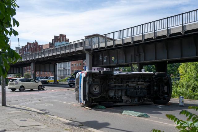 06 June 2026, Berlin: An overturned police car is lying on the road. Eight people were injured in a collision between a taxi and a police car, two of them seriously. Photo: Christophe Gateau/dpa