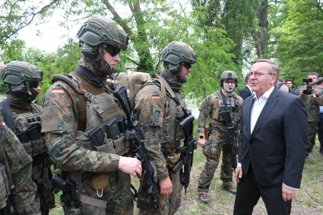 06 June 2026, Saxony-Anhalt, Weissenfels: Boris Pistorius, Germany's Defence Minister, speaks with soldiers from the Rapid Medical Response Force (SES) during Bundeswehr Day. Once a year, the military opens its doors to the public at various locations during the event. Photo: Sebastian Willnow/dpa