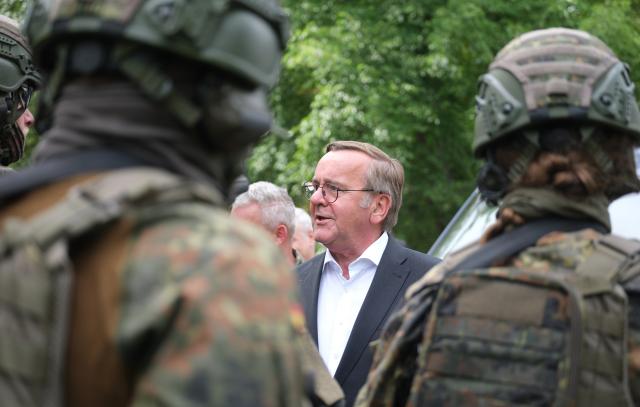 06 June 2026, Saxony-Anhalt, Weissenfels: Boris Pistorius, Germany's Defence Minister, speaks with soldiers from the Rapid Medical Response Force (SES) during Bundeswehr Day. Once a year, the military opens its doors to the public at various locations during the event. Photo: Sebastian Willnow/dpa