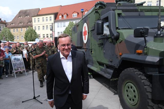 06 June 2026, Saxony-Anhalt, Weissenfels: Boris Pistorius, Germany's Defence Minister, walks past an "Igel" armoured vehicle during Bundeswehr Day. At this annual event, the military opens its doors to the public at various locations. Photo: Sebastian Willnow/dpa