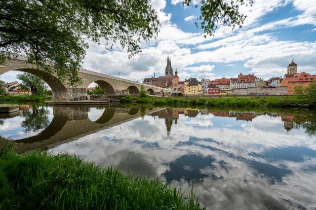FILED - 31 May 2021, Bavaria, Regensburg: File Photo - The medieval Stone Bridge spans the Danube River, with St. Peter's Cathedral visible in the background, in the historic Old Town of Regensburg, Germany. The city's exceptionally preserved medieval center is recognized as a UNESCO World Heritage site. Photo: Armin Weigel/dpa