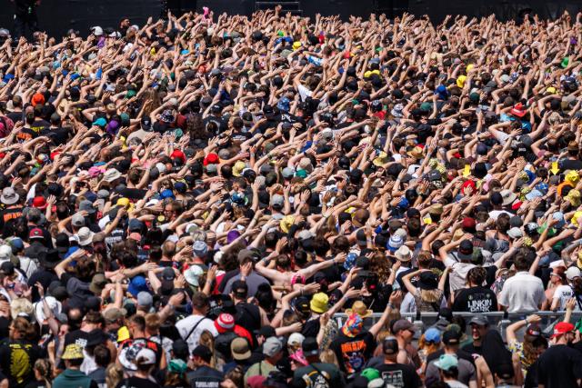 07 June 2026, Rhineland-Palatinate, Nuremberg: Visitors watch a concert with their arms raised during the Rock am Ring Open-Air Festival. Photo: Daniel Karmann/dpa