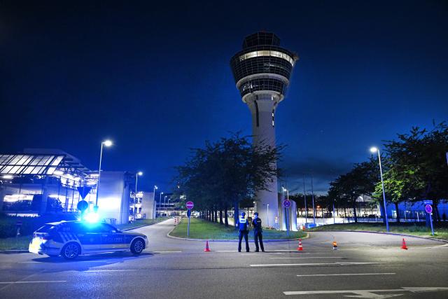 07 June 2026, Bavaria, Munich: Police officers stand in front of the control tower at Munich Airport. Flight operations at Munich Airport have been partially suspended. Photo: Sven Hoppe/dpa