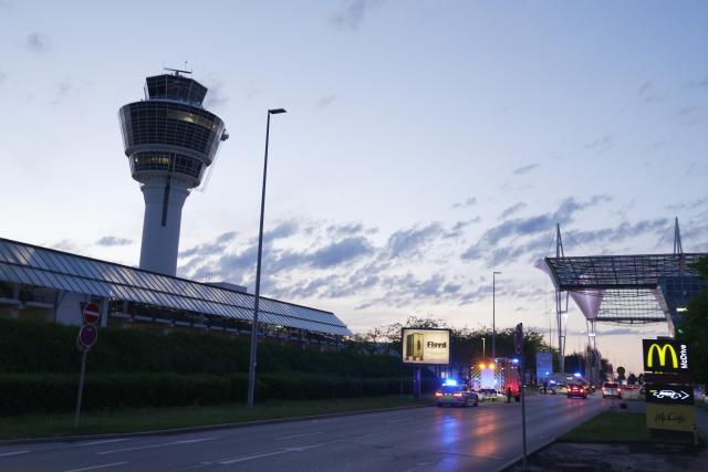 07 June 2026, Bavaria, Munich: Police and fire department vehicles stand in front of the control tower at Munich Airport. Flight operations at Munich Airport have been partially suspended. Photo: Ehsan Monajati/dpa