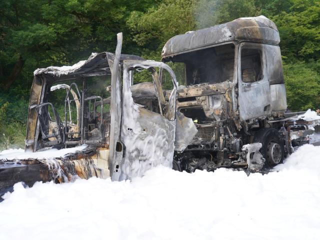 08 June 2026, Rhineland-Palatinate, Diez: Thick extinguishing foam covers two vehicles following a head-on collision on the B54 federal highway near Steinfurt, Germany. Both cars caught fire after the impact, prompting a large-scale response from local fire brigades; no injuries were reported in the accident. Photo: Sascha Ditscher/dpa