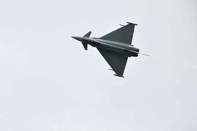 09 June 2026, Brandenburg, Schoenefeld: A Eurofighter Typhoon flies over the grounds of Berlin ExpoCenter Airport the day before the International Aerospace Exhibition begins. The ILA runs from June 10 to June 14. Photo: Sebastian Gollnow/dpa