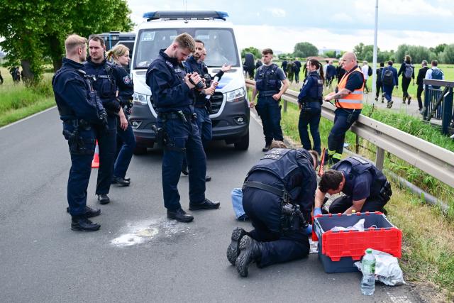 10 June 2026, Berlin, Berlin-Schönefeld: Police officers release a person stuck on an access road during the International Aerospace Exhibition (ILA) at Berlin ExpoCenter Airport. The ILA begins on June 10 and runs until June 14. Photo: Sebastian Christoph Gollnow/dpa