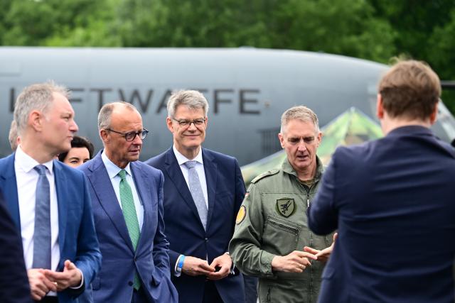 SYMBOL - 10 June 2026, Brandenburg, Schoenefeld: Friedrich Merz, German Chancellor, and Patrick Schnieder, German Minister of Transport, visit the Bundeswehr static display during a tour of the International Aerospace Exhibition (ILA). Photo: Sebastian Gollnow/dpa
