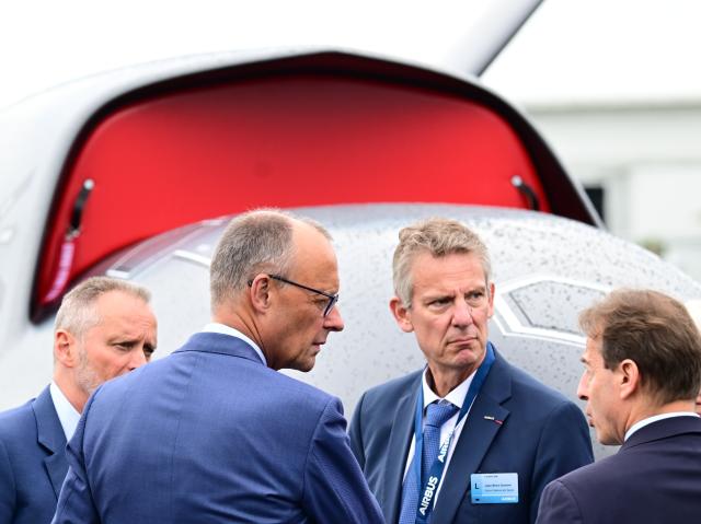 SYMBOL - 10 June 2026, Brandenburg, Schoenefeld: German Chancellor Friedrich Merz (2nd L) and Jean-Brice Dumont (2nd R), Head of Air Power at Airbus Defence and Space, stand in front of a drone during a tour of the International Aerospace Exhibition (ILA). Photo: Sebastian Gollnow/dpa
