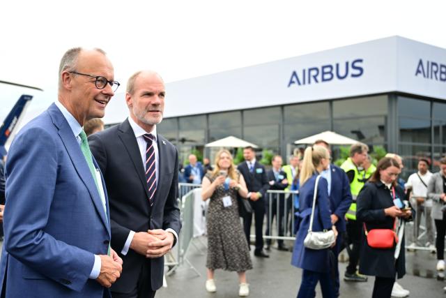 SYMBOL - 10 June 2026, Brandenburg, Schoenefeld: German Chancellor Friedrich Merz (L) and Lars Wagner of Airbus during a tour of the International Aerospace Exhibition (ILA). Photo: Sebastian Gollnow/dpa