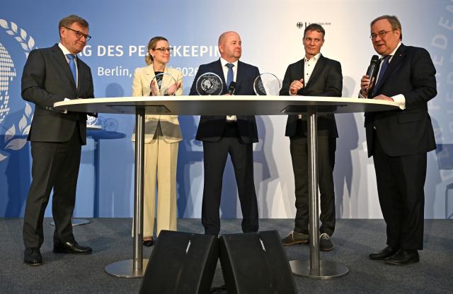 11 June 2026, Berlin: (L-R) Johann Wadephul, Germany's Foreign Minister; Patricia Albermann, Strategic Communication Advisor at the NATO Liaison Office in the Republic of Moldova; Thomas Hofmann, Head of Security and Health (SMSO), and Thomas Körner, Head of the International Crimes Legal Unit, are pictured at the award ceremony for "Peacekeeping Day" at the Federal Foreign Office. The day honors the work of German civilian experts, police officers, and soldiers in international peacekeeping missions. Photo: Elisa Schu/dpa