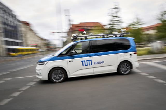 FILED - 09 June 2026, Berlin: FILE PHOTO - A Volkswagen VW T7 from the Technical University of Munich (TU), used as an autonomous research vehicle named Edgar, is driving through the city center. For the first time in Germany, a test drive for autonomous driving was conducted under real-world Level 4 conditions in city traffic. Photo: Michael Ukas/dpa