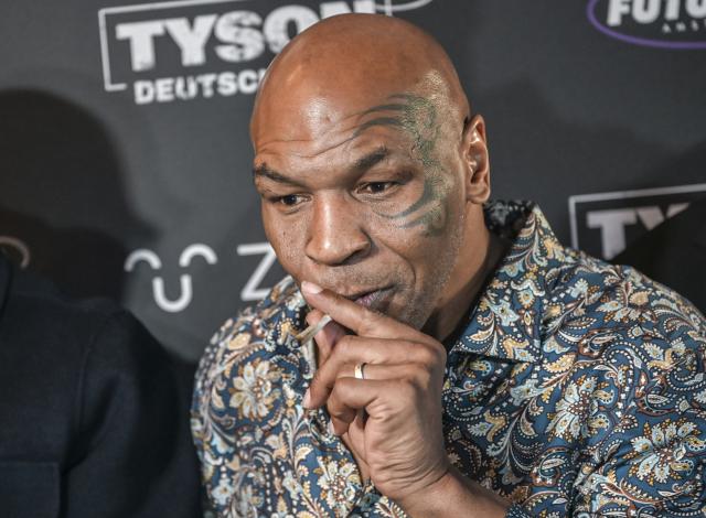 11 June 2026, Berlin: Former US boxer Mike Tyson smokes a joint during an event on the sidelines of the Mary Jane Berlin Cannabis fair. Tyson owns cannabis farms and sells marijuana products. Guests were invited to the Bellucci restaurant for the industry gathering "Tyson 2.0. Culture. Health. Influence." Photo: Jens Kalaene/dpa