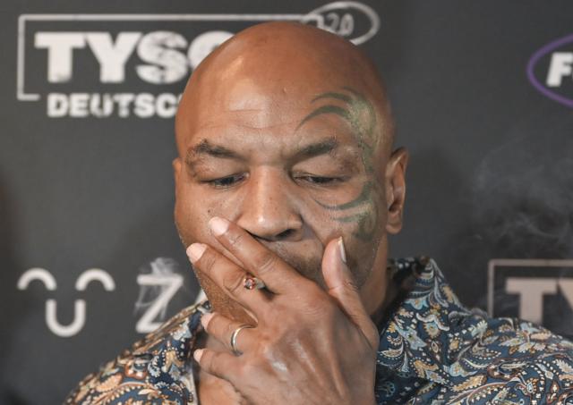 11 June 2026, Berlin: Former US boxer Mike Tyson smokes a joint during an event on the sidelines of the Mary Jane Berlin Cannabis fair. Tyson owns cannabis farms and sells marijuana products. Guests were invited to the Bellucci restaurant for the industry gathering "Tyson 2.0. Culture. Health. Influence." Photo: Jens Kalaene/dpa
