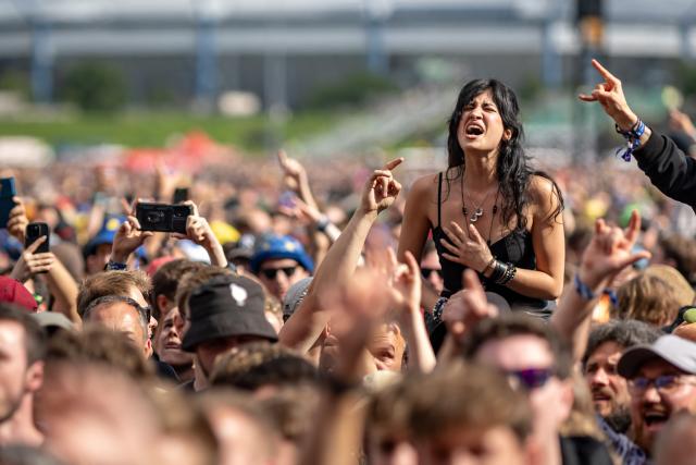 FILED - 05 June 2026, Bavaria, Nuremberg: Visitors at the rock open-air festival watch a rock concert. Photo: Daniel Karmann/dpa