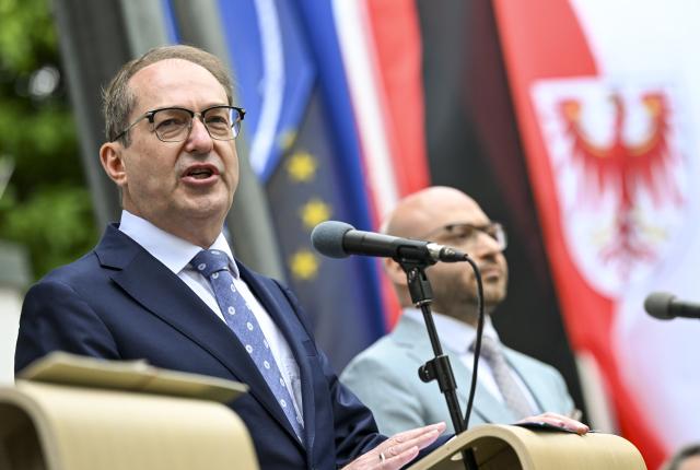 12 June 2026, Brandenburg, Schönefeld: German Interior Minister Alexander Dobrindt (L) of the Christian Social Union (CSU) speaks at the opening of the State of Brandenburg's external border facility at BER Airport, which begins operations today as the reform of the Common European Asylum System (CEAS) takes effect. Photo: Jens Kalaene/dpa