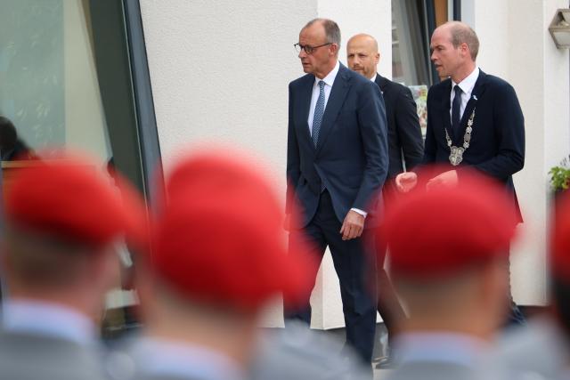 13 June 2026, North Rhine-Westphalia, Medebach: Friedrich Merz (C), Germany's Chancellor, and Frank Linnekugel (R), Mayor of Medebach, attend the Bundeswehr's ceremonial oath-taking ceremony. Recruits from the 21st Armored Brigade in Ahlen and Unna take their oath of service. Photo: Christoph Reichwein/dpa